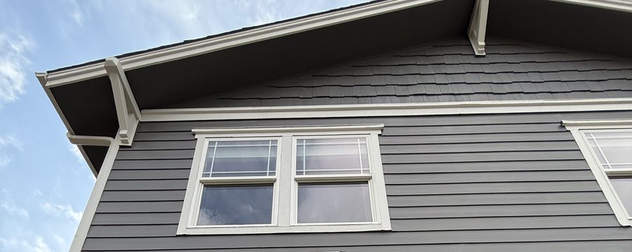 Gutter cleaning and guard installation on a Colorado home roofline